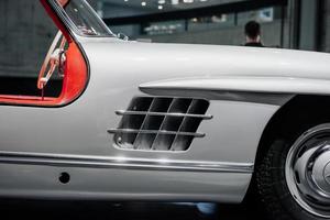 STUTTGART, GERMANY - OCTOBER 16, 2018 Mercedes Museum. Human's head on the background. Front part of the white retro vehicle photo