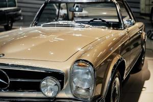 STUTTGART, GERMANY - OCTOBER 16, 2018 Mercedes Museum. Brown car from retro collection parked indoors at auto show photo