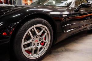 SINSHEIM, GERMANY - OCTOBER 16, 2018 Technik Museum. Left and front part of outstanding black car that parked indoors at automobile exhibition photo