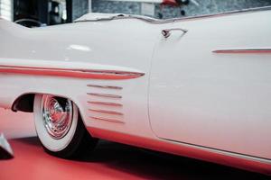 SINSHEIM, GERMANY - OCTOBER 16, 2018 Technik Museum. White vintage cabriolet on the red surface. Rear part photo