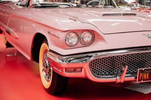 SINSHEIM, GERMANY - OCTOBER 16, 2018 Technik Museum. Car show. Beautiful retro automobile parked indoors at red tile photo