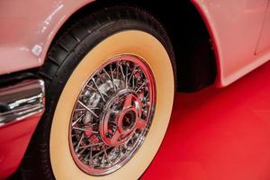 SINSHEIM, GERMANY - OCTOBER 16, 2018 Technik Museum. Particle view on the front of vintage car. Creamy colored wheel