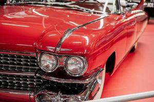 SINSHEIM, GERMANY - OCTOBER 16, 2018 Technik Museum. Front and left parts. Beautiful polished red vintage car. Cabriolet style photo