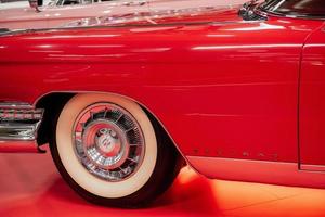 SINSHEIM, GERMANY - OCTOBER 16, 2018 Technik Museum. Side part of the red vintage car. Front creamy colored wheel