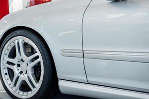 Front part of modern white bright car standing indoors photo