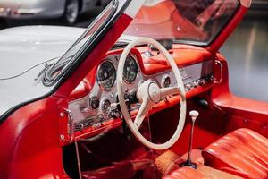 STUTTGART, GERMANY - OCTOBER 16, 2018 Mercedes Museum. White steering wheel and red interior. Inside of expencive collectible vintage car photo