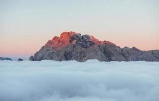 Sun leaving the place. It is visible on the disappearing lights. The peaks of the mountains stifle from a going thick fog. Unbelievable photo takes