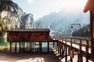Construction to the brown house and side view of it. Good landscape with mountains. Touristic place with wooden building and pear photo