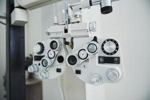 Phoropter standing in the office. Ophthalmologist devices in the beautiful white room photo