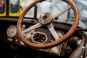 Focused photo of the brown steering wheel of an old retro automobile