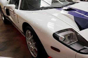 SINSHEIM, GERMANY - OCTOBER 16, 2018 Technik Museum. Close up view. Great white sport automobile with blue lines parked indoors at car show