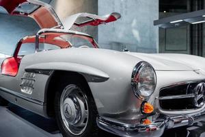 STUTTGART, GERMANY - OCTOBER 16, 2018 Mercedes Museum. Gorgeous piece of classic. White retro vehicle with red salon and opened doors standing at car show photo