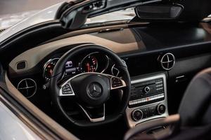 STUTTGART, GERMANY - OCTOBER 16, 2018 Mercedes Museum. Dashboard is on. Inside of brand new car with black interior photo