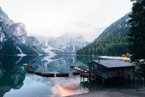 Person walking on the footway. Good landscape with mountains. Touristic place with wooden building and pear photo