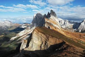 Beautiful sunlight breaks through the clouds. Outstanding hills of the Seceda dolomite mountains at daytime