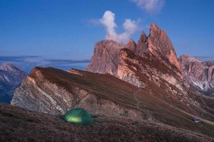 tarde y niebla. carpa verde de pie en la colina. lugar impresionante en los alpes de seceda foto