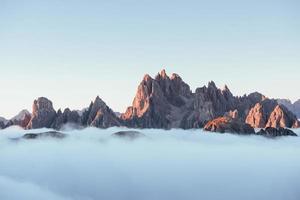 It's all bigger than you think. The peaks of the mountains stifle from a going thick fog. Unbelievable photo takes