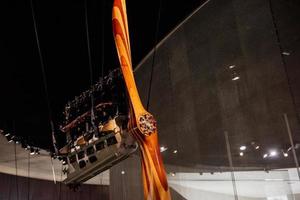 Wooden brown and white colored propeller engine hanging on ropes photo