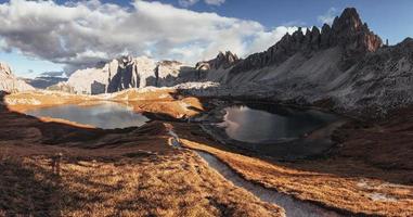 Valley with lakes in the majestic dolomite mountains at sunny day. Panoramic photo