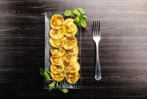 Italian stuffed pasta ravioli with pesto sauce photo