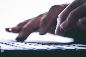 Hands typing on the computer keyboard. Modern style photo