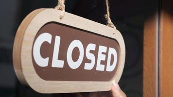 Small business close. Turning the sign to closed photo