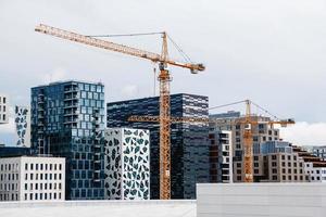 Building crane on the background of buildings photo