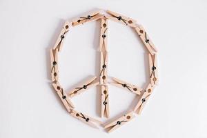 Wooden clothespins on a white background which are composed of peace and hippie icon photo