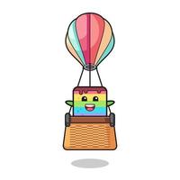 rainbow cake mascot riding a hot air balloon vector