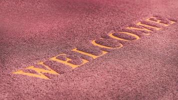 Close-up of welcome message on dark red doormat, background. photo