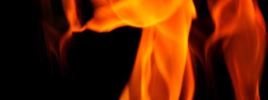 Fire background. Abstract burning flame and black background. photo