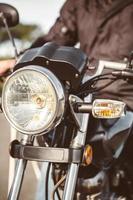 Motorcycle headlights with senior man steering photo