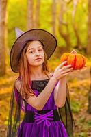 Girl 11 years old against the background of autumn nature. Little girl in Halloween costume, autumn. photo