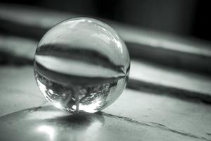 Monochrome image of a lens ball on an old window sill