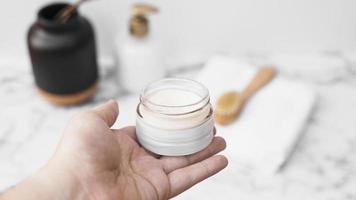 human hand holding jar moisturizing cream. High quality beautiful photo concept