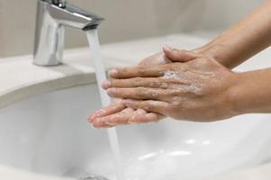 person washing hands close up photo