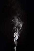 white smoke raising black background with copy space photo