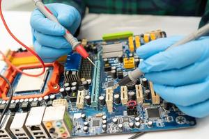 technician repairing inside of hard disk by soldering iron. Integrated Circuit. the concept of data, hardware, technician and technology. photo