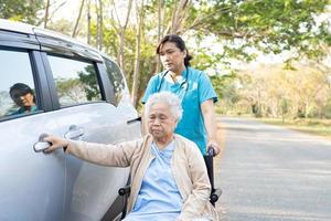 Asian senior or elderly old lady woman patient sitting on wheelchair prepare get to her car, healthy strong medical concept. photo