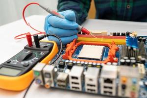 technician repairing inside of hard disk by soldering iron. Integrated Circuit. the concept of data, hardware, technician and technology. photo