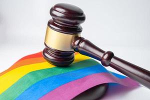 Gavel for judge lawyer on rainbow flag, symbol of LGBT pride month celebrate annual in June social of gay, lesbian, bisexual, transgender, human rights. photo