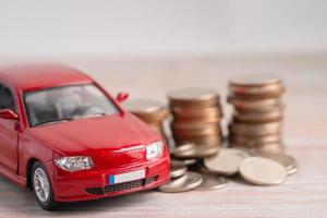 Car on coins background Car loan, Finance, saving money, insurance and leasing time photo