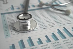 Stethoscope on spreadsheet paper, Finance, Account, Statistics, Investment, Analytic research data economy spreadsheet and Business company concept. photo