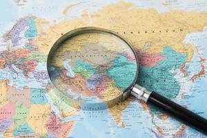 Bangkok, Thailand - August 01, 2020 Europe, Magnifying glass close up with colorful world map, Magnifying glass close up with colorful world map photo