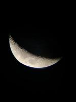 View of The Moon through a telescope photo