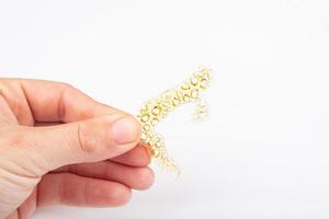 piece of wax with cannabis in hand on a white background close-up photo