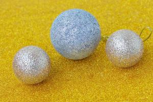 white christmas balls on glittering gold background photo