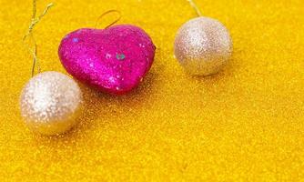 Christmas hearts on glittering gold background photo
