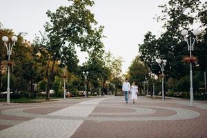 guy and a girl happily walk in the morning on the empty streets photo