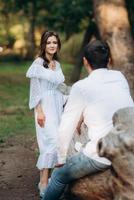 guy and a girl walk along the paths of a forest park photo